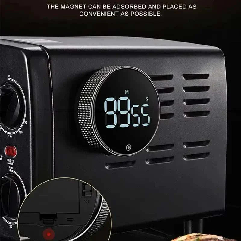 Magnetic kitchen timer on appliance with digital display showing 98:55 seconds.
