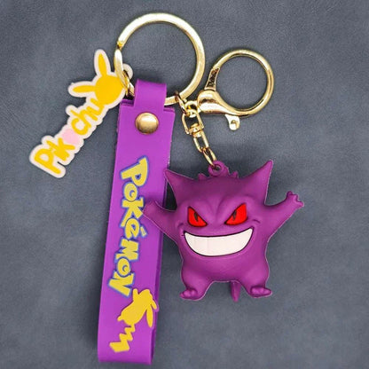 Purple Pokemon keychain with Pikachu and Koda Duck pendant, featuring a Gengar figurine and gold lobster clasp.
