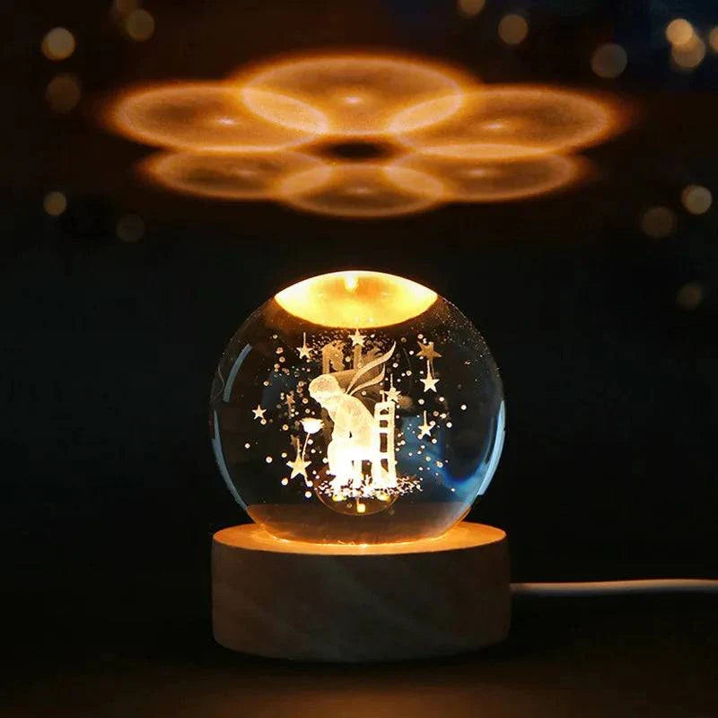 6cm 3D crystal ball with laser-engraved solar system design, illuminated on a wooden base.
