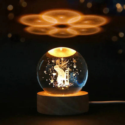 6cm 3D crystal ball with laser-engraved solar system design, illuminated on a wooden base.