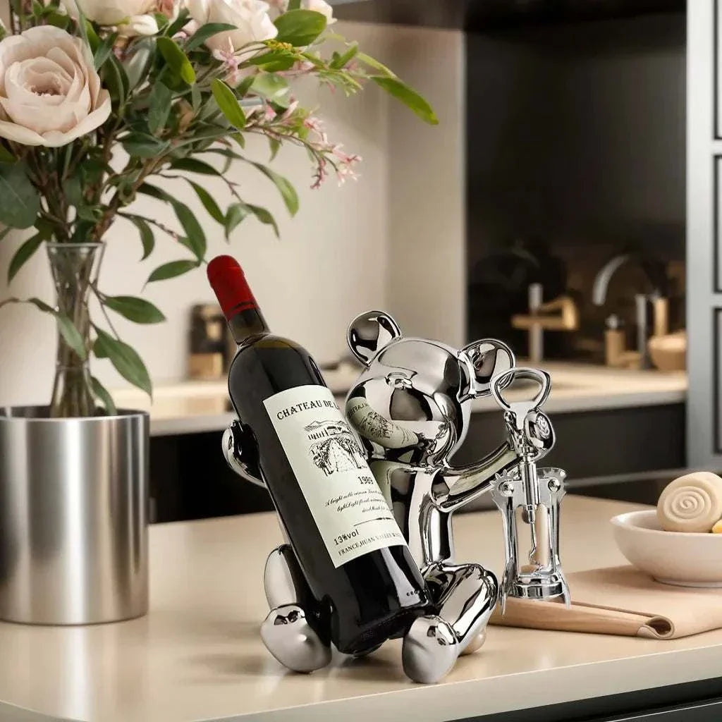Ceramic bear wine rack holding wine bottle in modern kitchen setting.