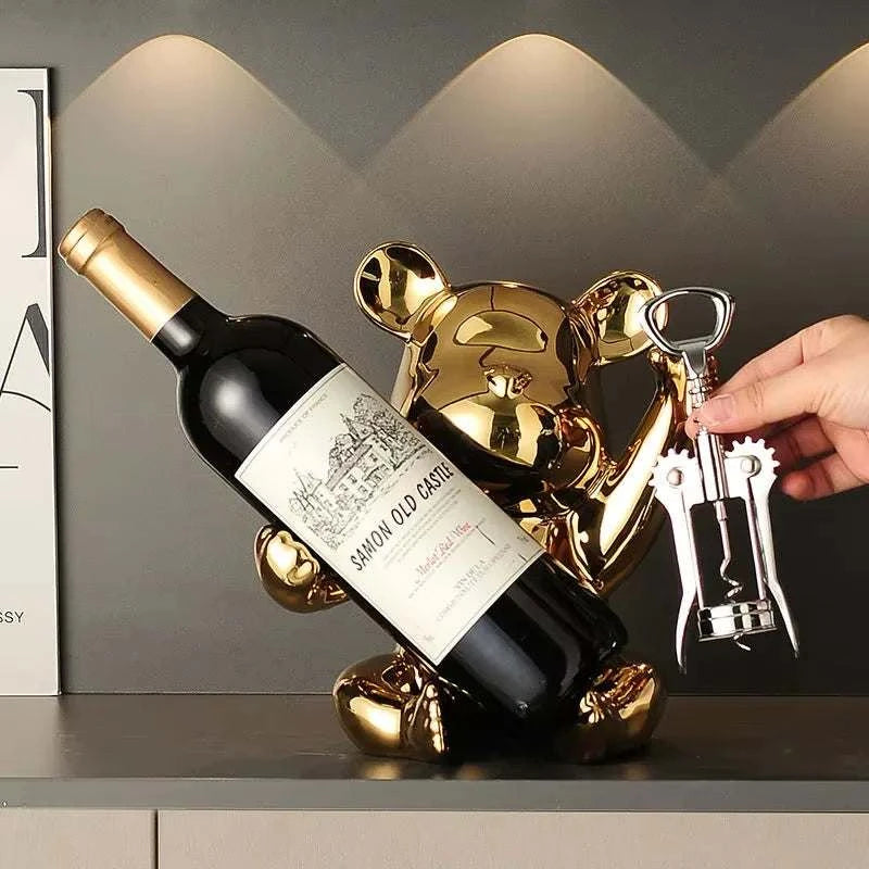 Ceramic bear wine rack holding a bottle, ideal for home or bar decoration.