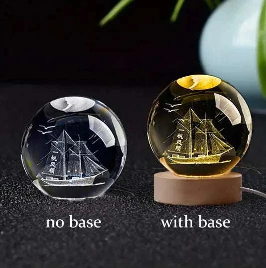 6cm 3D crystal ball with laser-engraved ship design on a desktop.