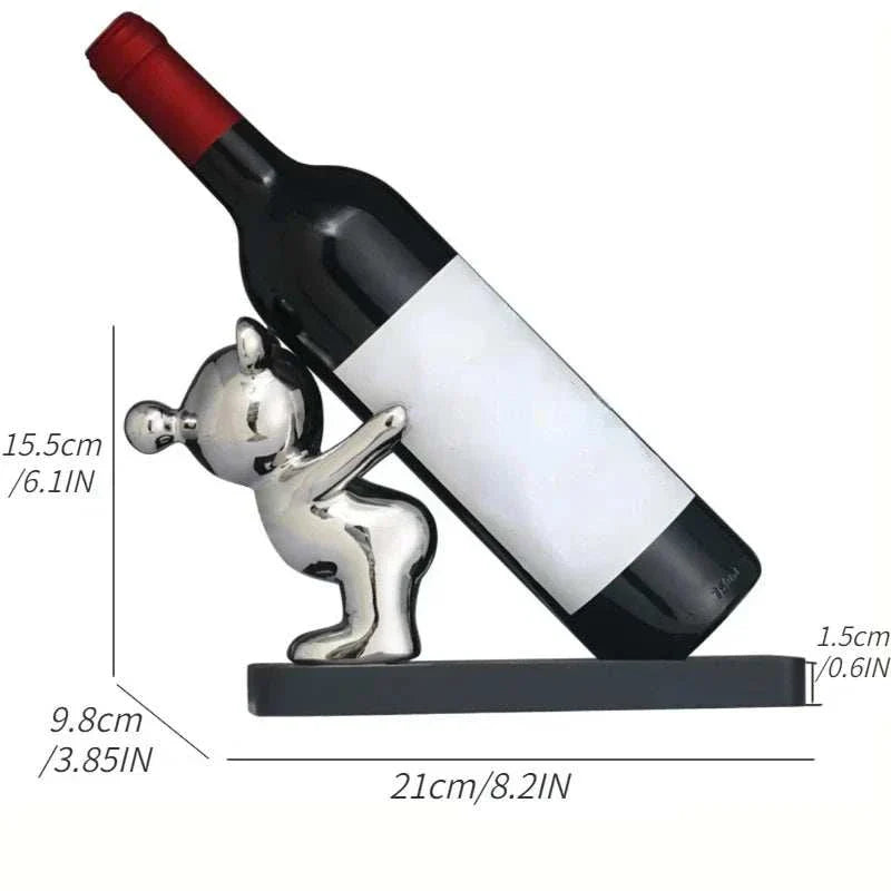 Ceramic bear wine rack with plastic base holding a wine bottle, ideal for home decor and kitchen storage.